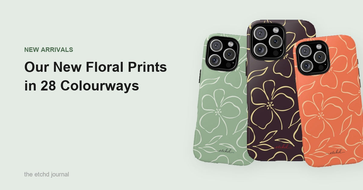 Three etchd floral phone cases in sage, espresso and coral, each with a large hand drawn bloom