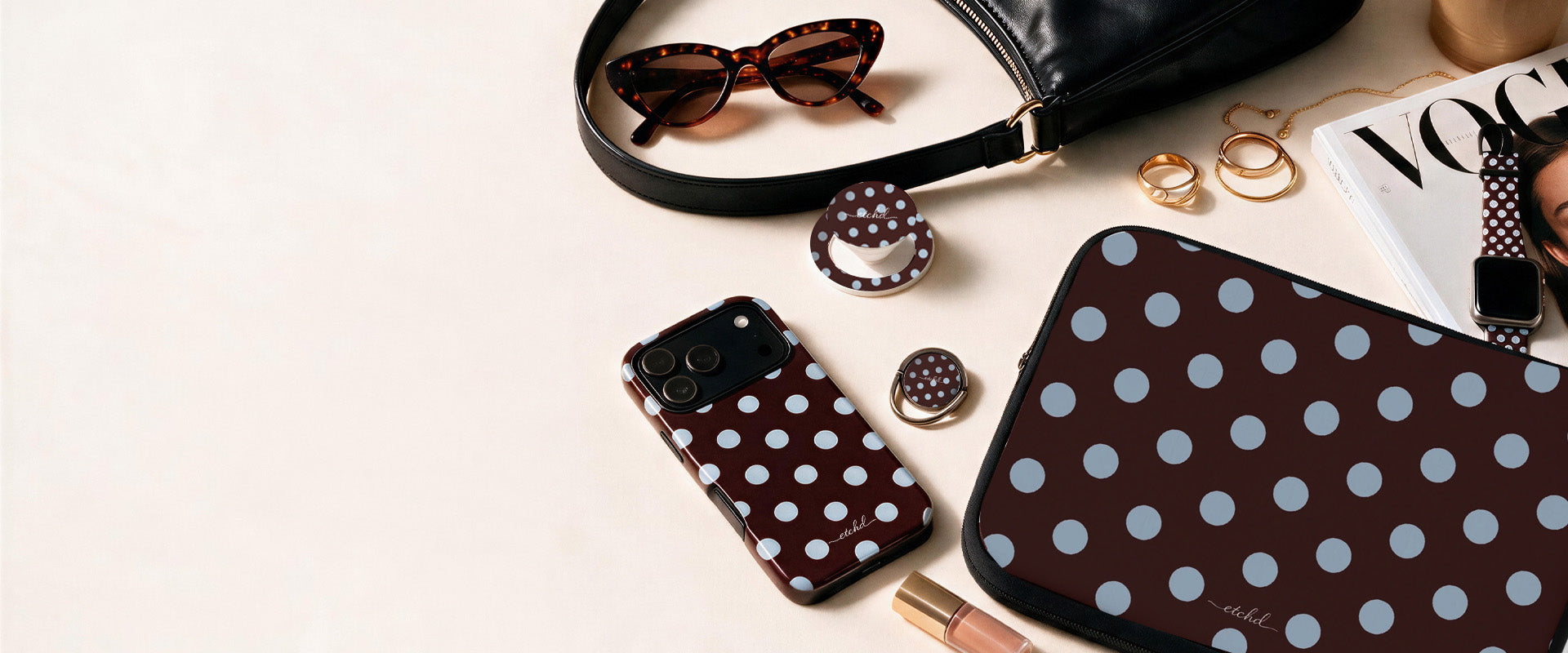Matching brown polka dot phone case, laptop sleeve, phone grip and watch strap by etchd, styled with sunglasses and a handbag