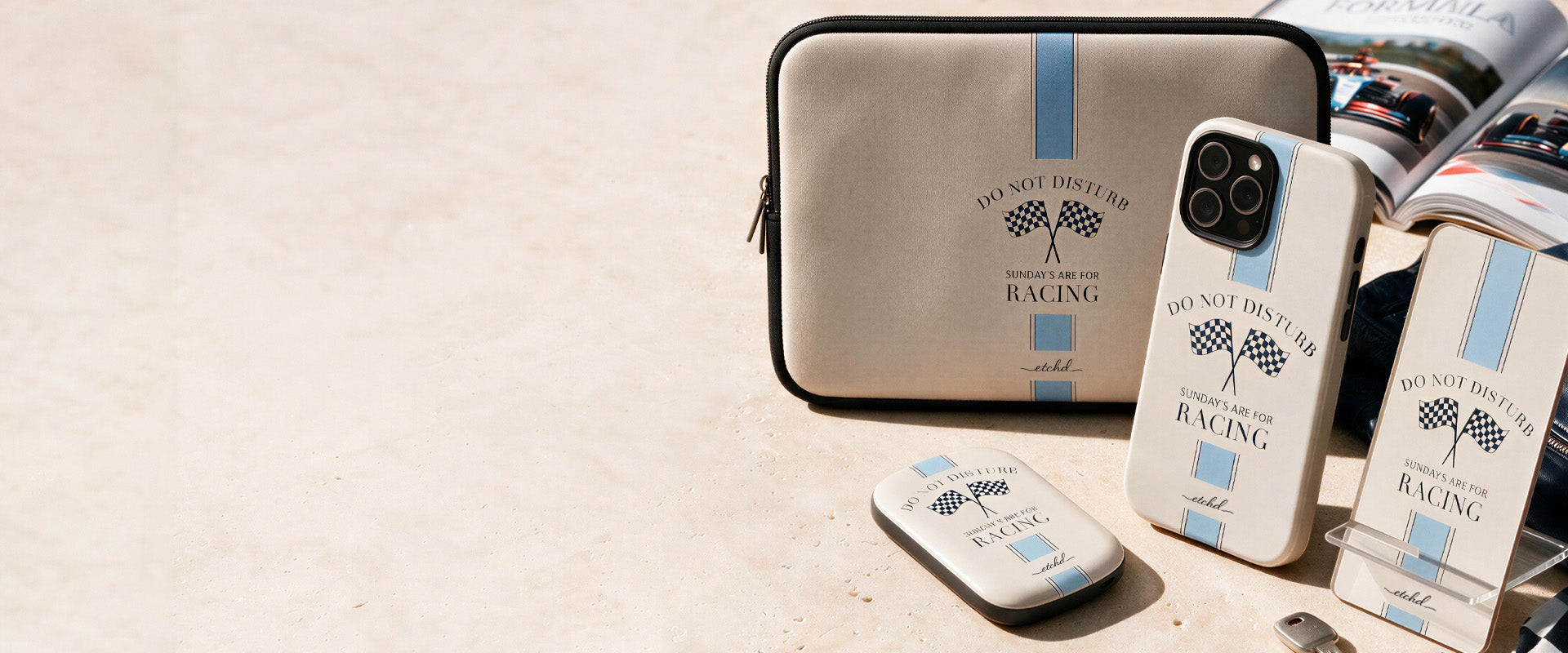 Sunday Racing laptop sleeve, phone case, power bank and phone stand by etchd in cream and blue with chequered flags
